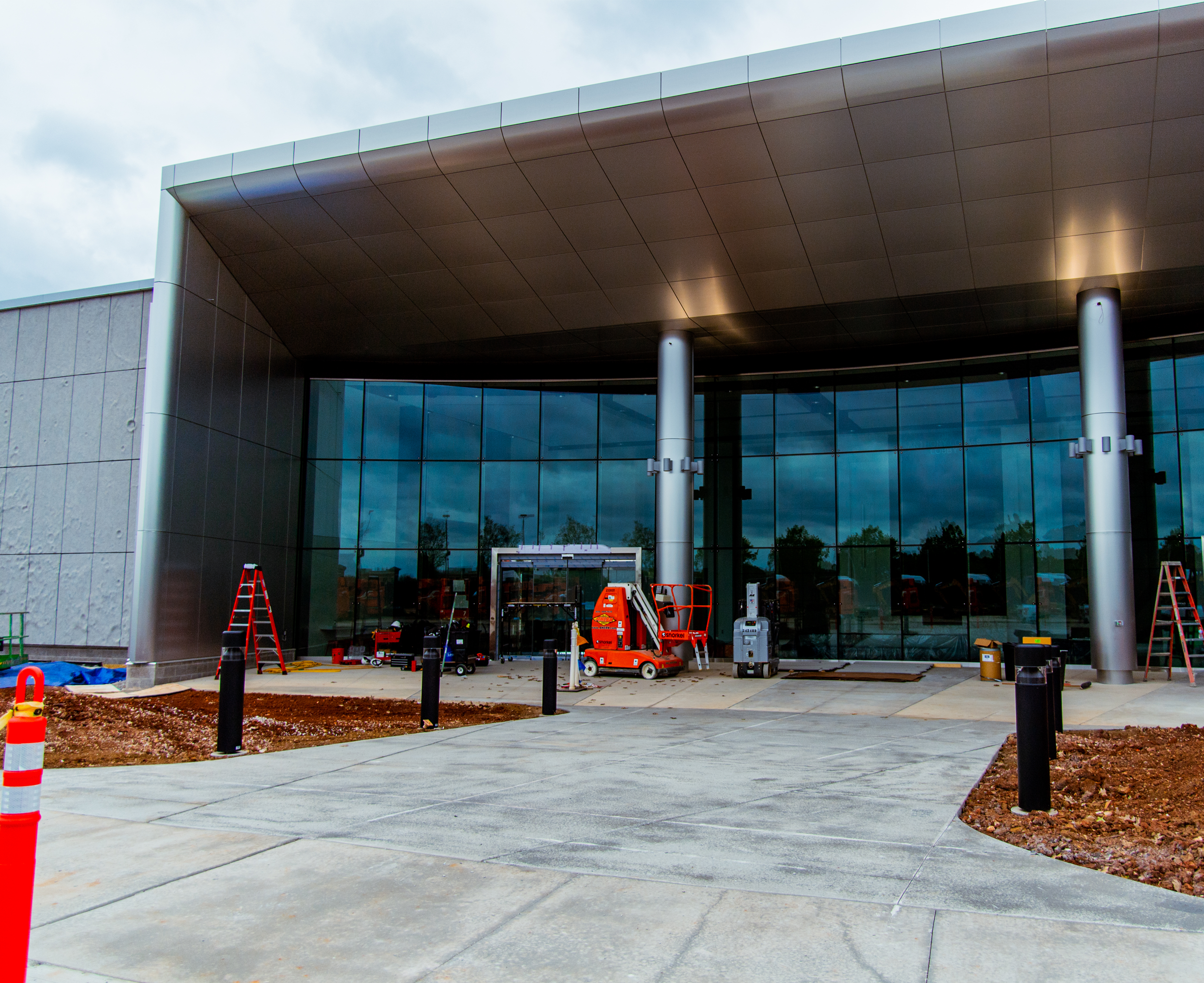 Construction equipment, cones, and ladders sit outside the Space Camp Operations Center